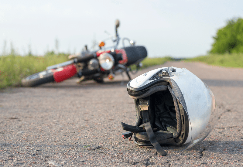 Helmet and bike laying in road after motorcycle accident in dallas