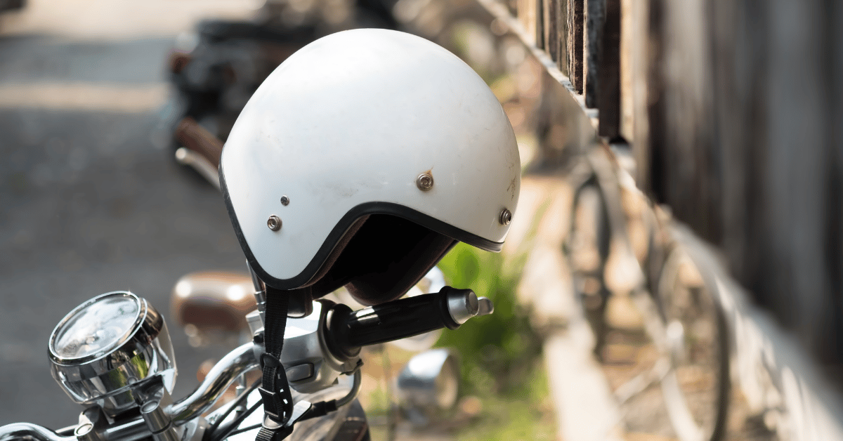 A helmet hanging on motorcycle wheel