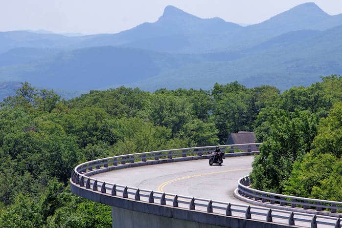 A lone motorcycle rally attendee rides through the mountains in North Carolina