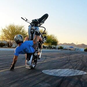 Ryan Kruesi demonstrates a wheelie during a stunt show.