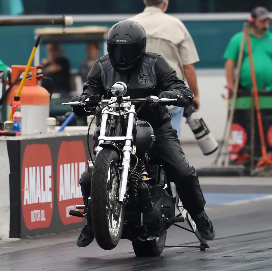 Chris Phipps Harley Drag racer hops off the line during the Jim McClure All-Harley World Finals Oct. 27.