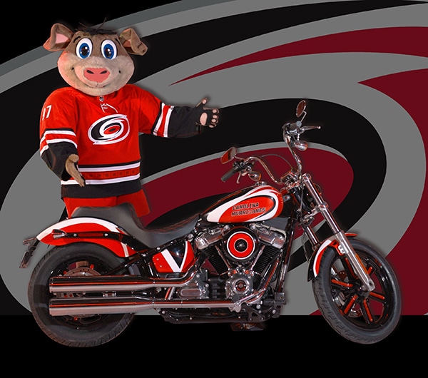 Photo of Caniac mascot and Harley-Davidson motorcycle for giveaway