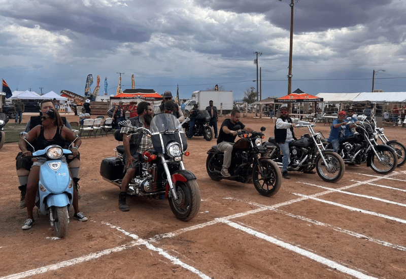 Motorcycles and riders lined up at race line about to start at too broke for sturgis
