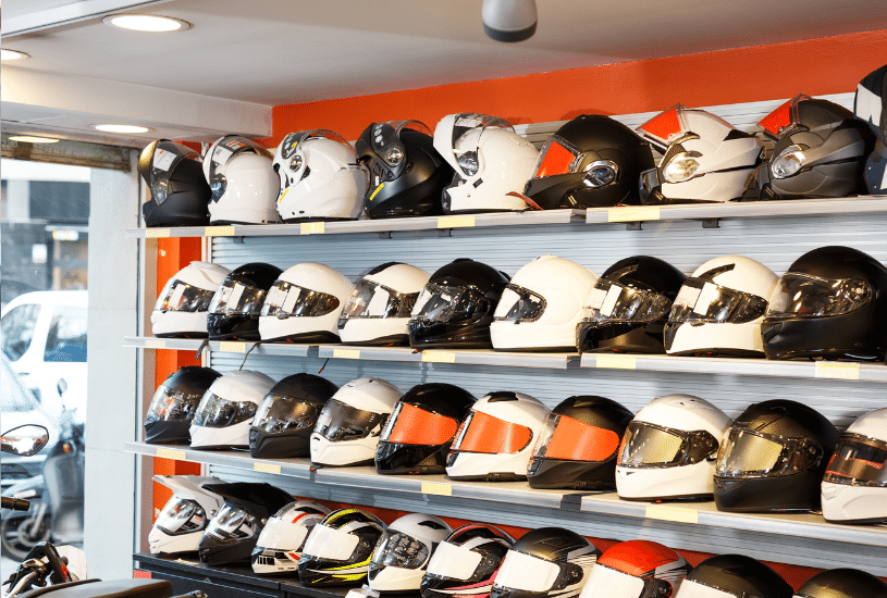 a row of motorcycle helmets on the shelf